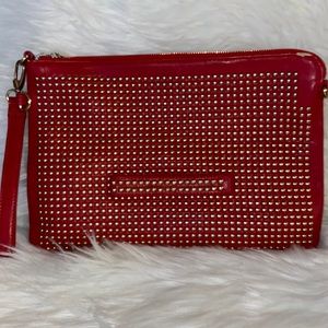 Red clutch wristlet, gold metal studded hardware long shoulder strap included.